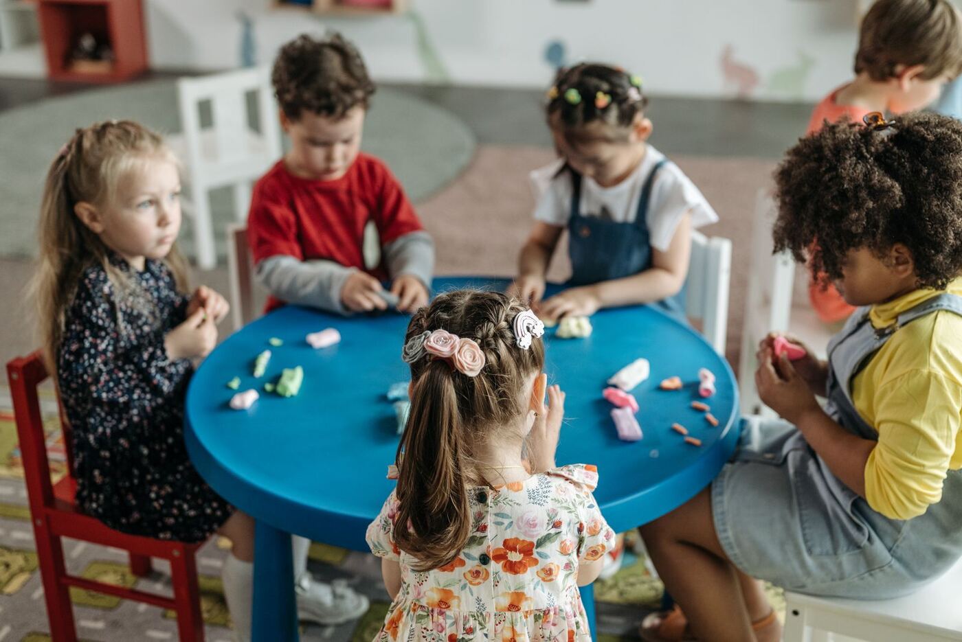 Preschoolers playing together at a classroom table