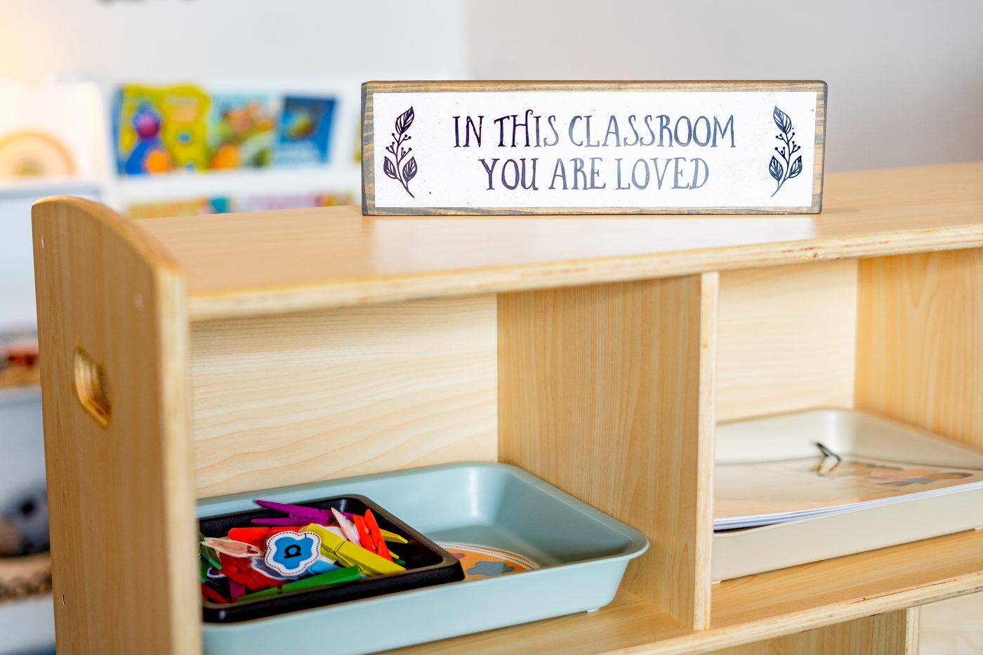 A wooden sign in a Hope Kids Preschool classroom that reads In This Classroom You Are Loved